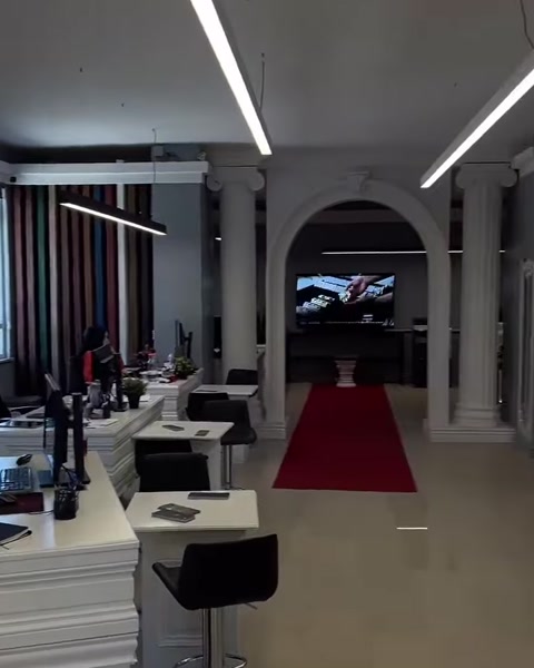 Sütunlar ve kemerli geçişlerle düzenlenmiş uzun showroom koridoru