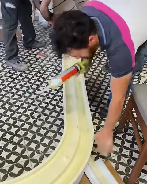 Kavisli çıtanın arka yüzüne montaj malzemesi uygulanıyor