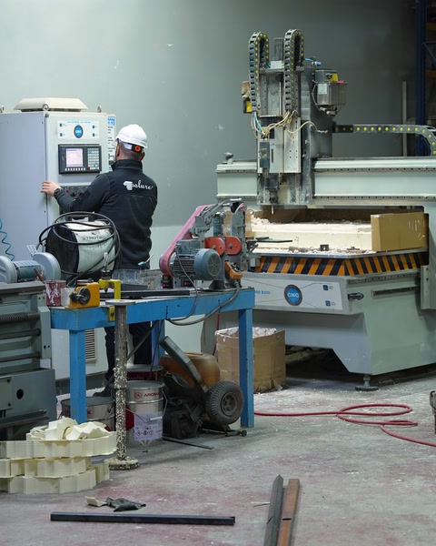 Üretim çalışanı endüstriyel makine başında kalıp işlemini yürütüyor